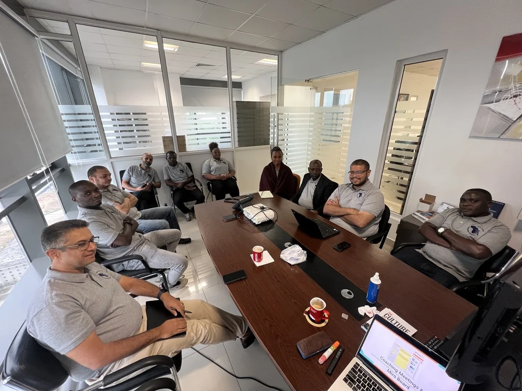 Trans Africa Insurance Brokers team members meet around a conference table.