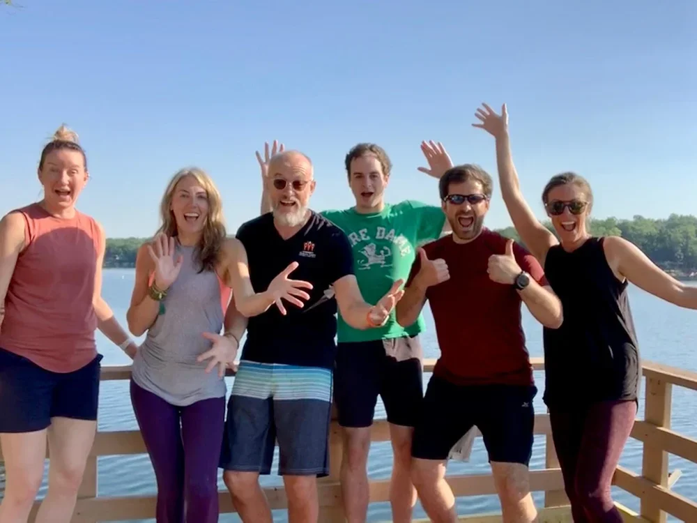 CPL Investments team members pose together beside the lake.