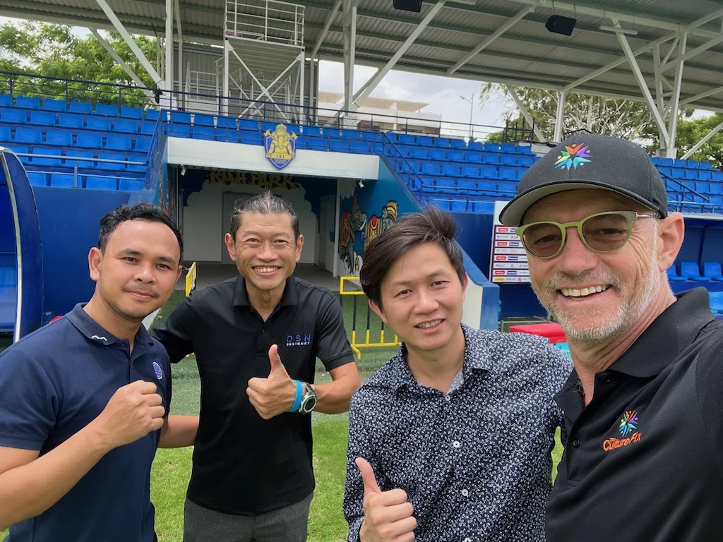 Will Scott poses with colleagues during a factory visit.