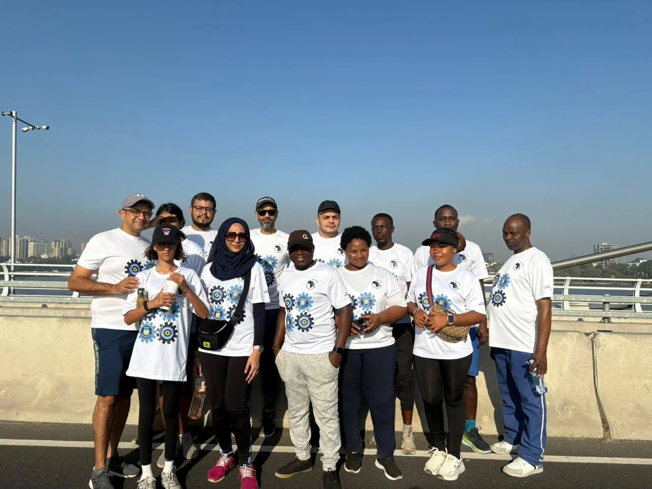 Trans Africa Insurance Brokers team members wear matching shirts for an outdoor group photograph.