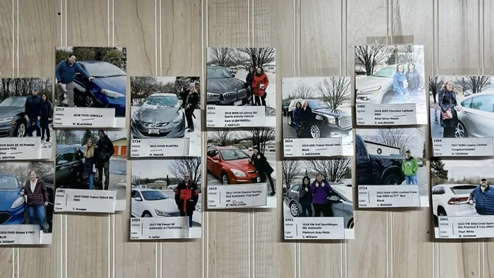 Employee stories and photographs displayed on an office wall.
