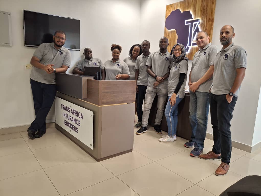 Trans Africa Insurance Brokers team members stand together in their office reception area.